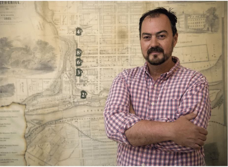 Chris Bowen, brewer, in front of the Bethlehem Brewery Map