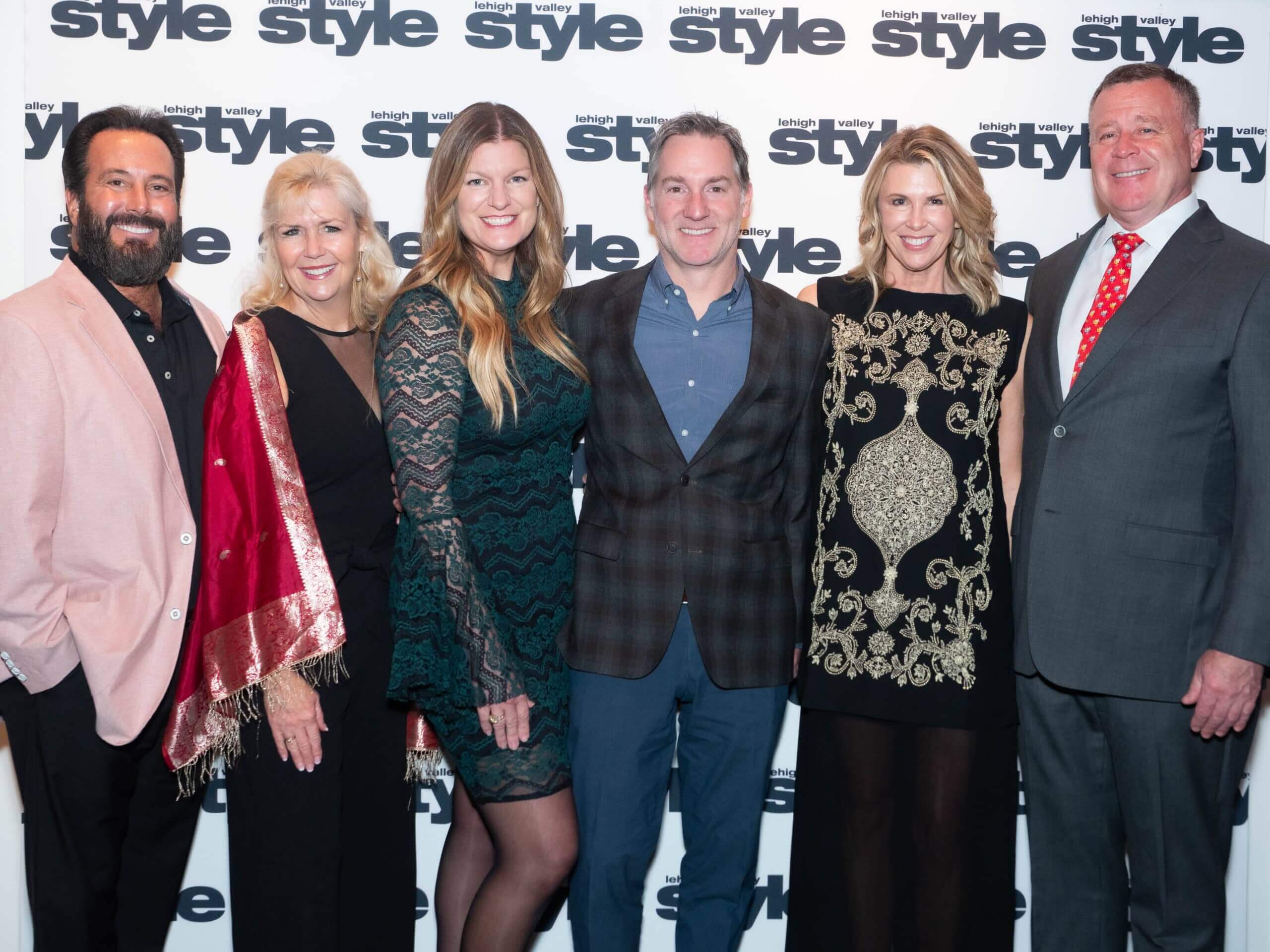 Baum and Van de Voorde in front of the Lehigh Valley Style background at the Holiday Dinner & Auction