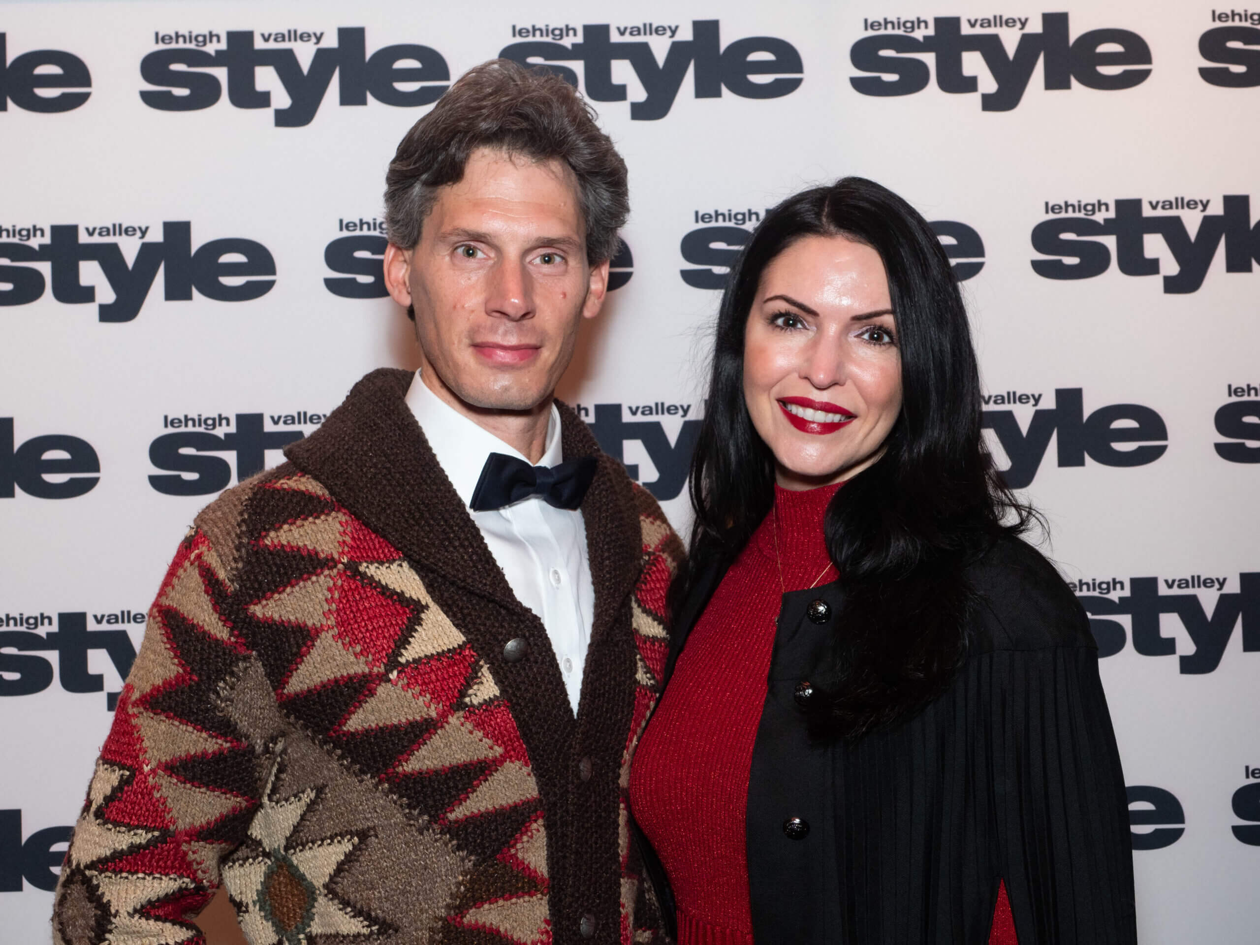 Bo and Jennifer Koltnow in front of the Lehigh Valley Style background at the Holiday Dinner & Auction