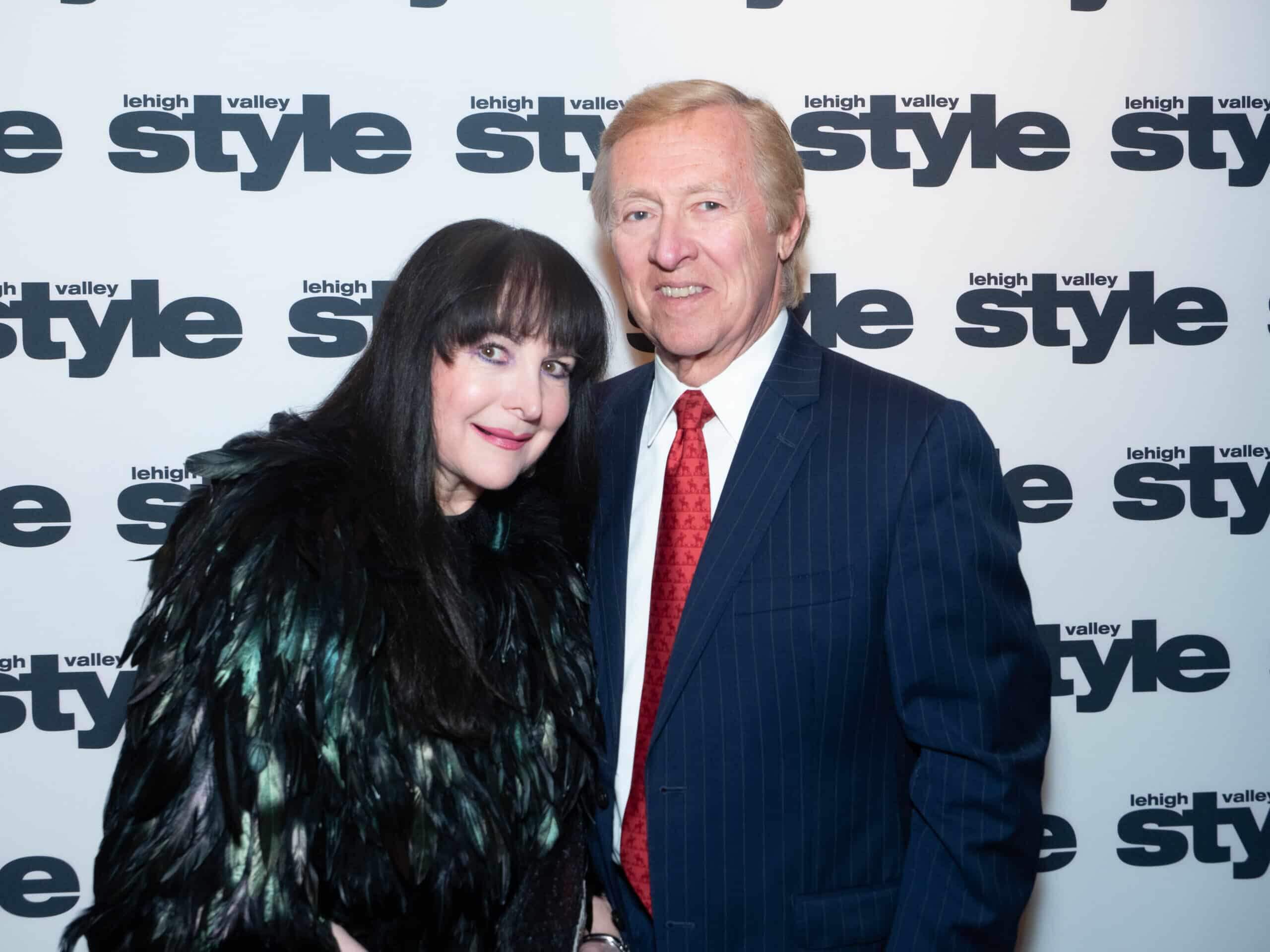 Ilene Wood and Ray Starner in front of the Lehigh Valley Style background at the Holiday Dinner & Auction