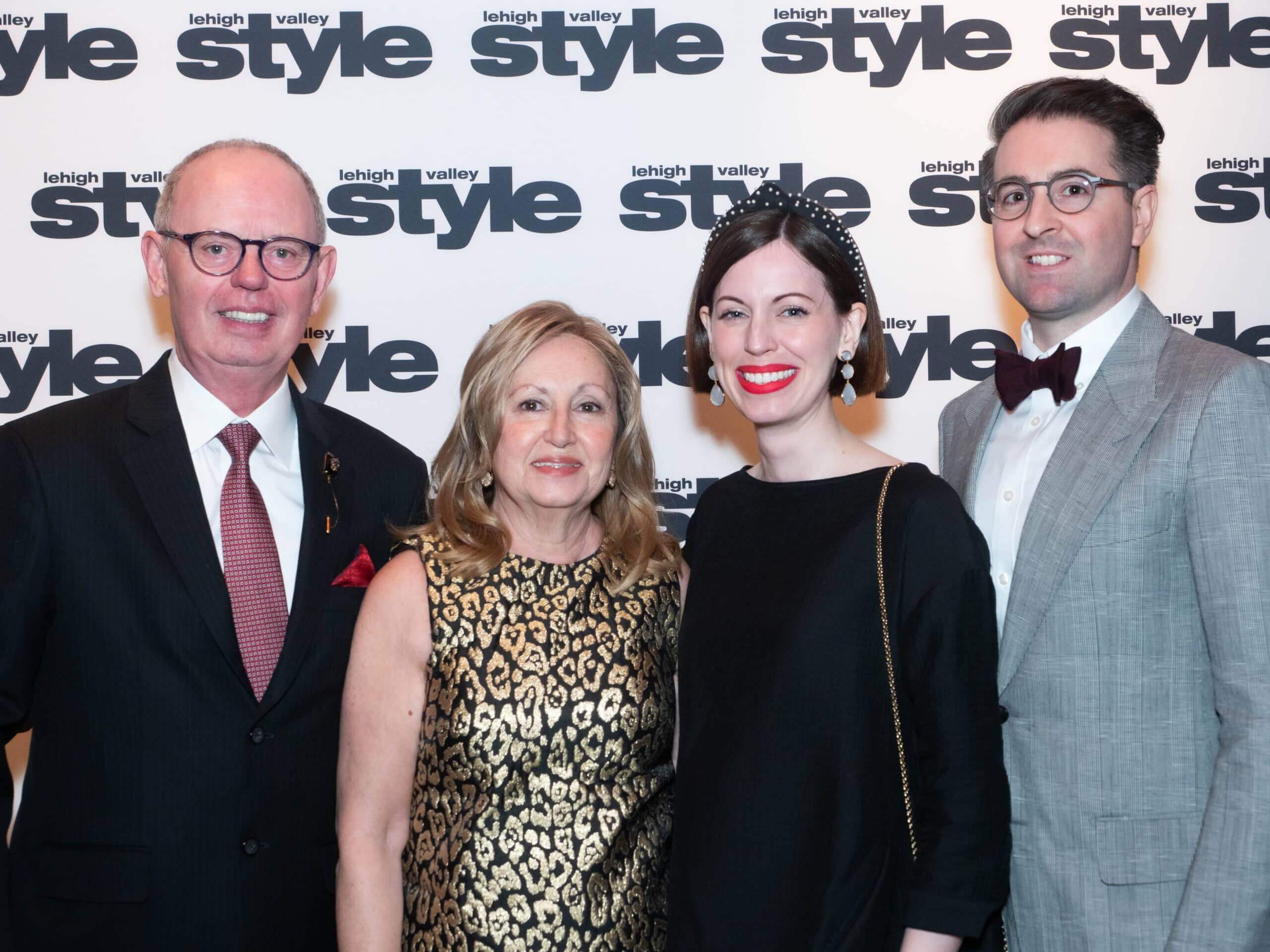 The Kellys in front of the Lehigh Valley Style background at the Holiday Dinner & Auction