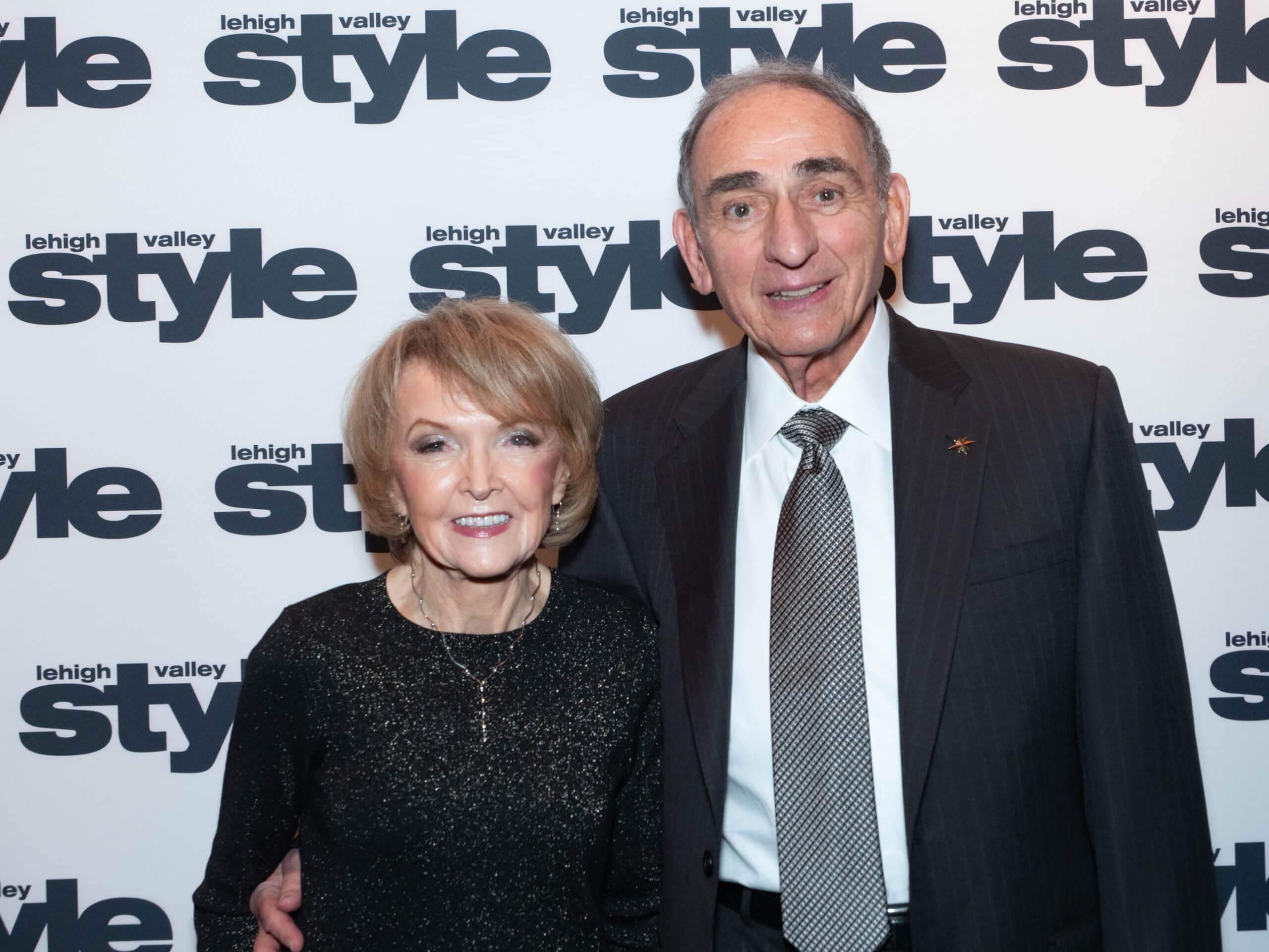 Billy and Patti Lehr in front of the Lehigh Valley Style background at the Holiday Dinner & Auction