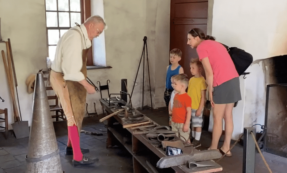 Blacksmith providing a demonstration for a family