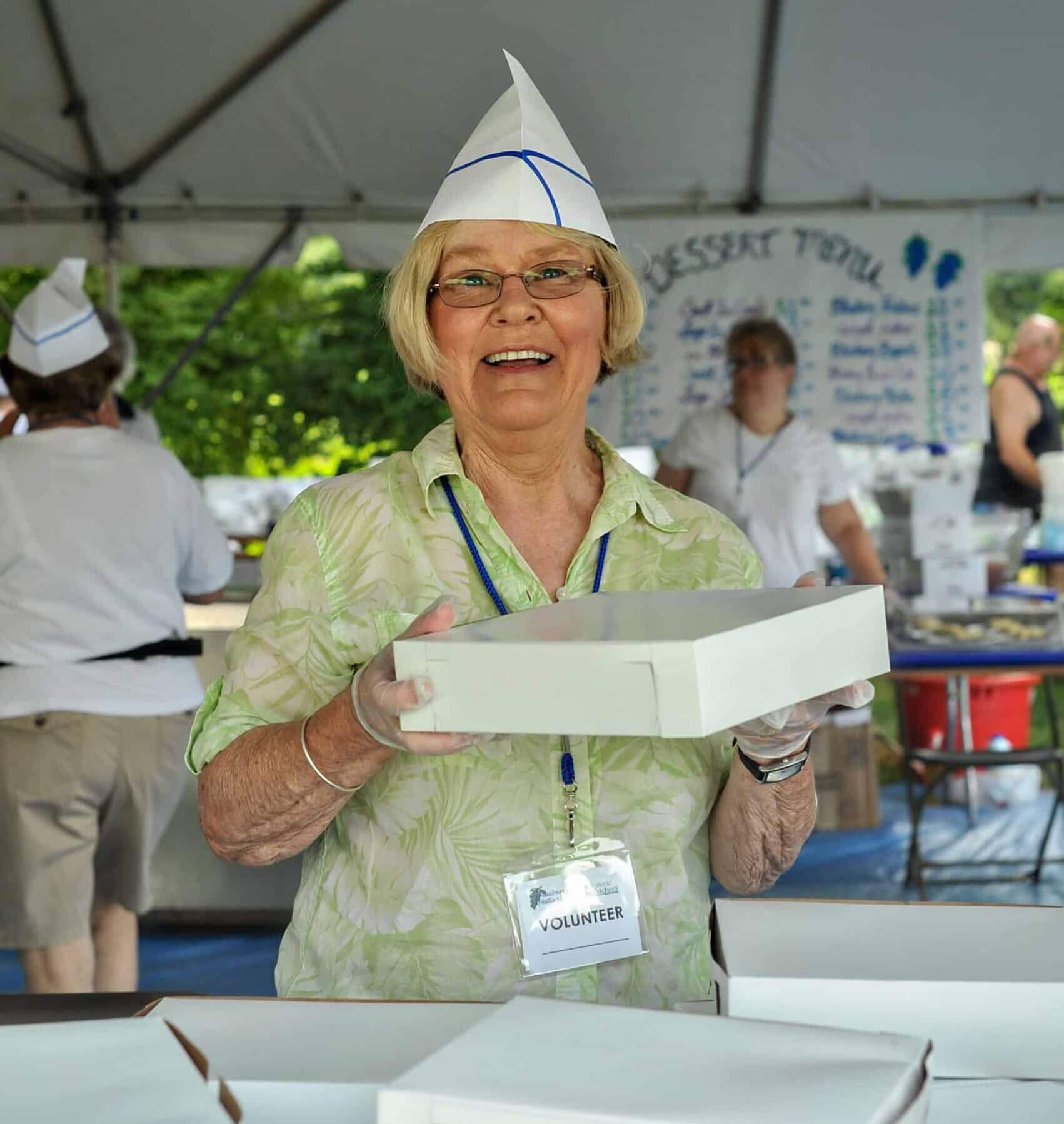 http://Women%20volunteering%20at%20Blueberry%20Festival