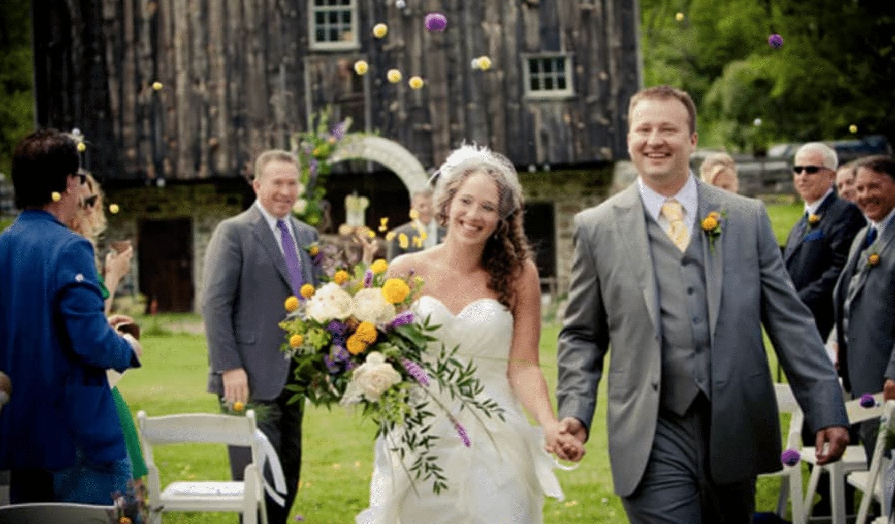 A bride and groom walk down the aisle holding hands during a wedding at Burnside Plantation