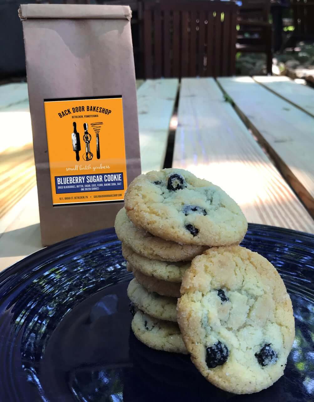 Seven blueberry sugar cookies are displayed on a plate