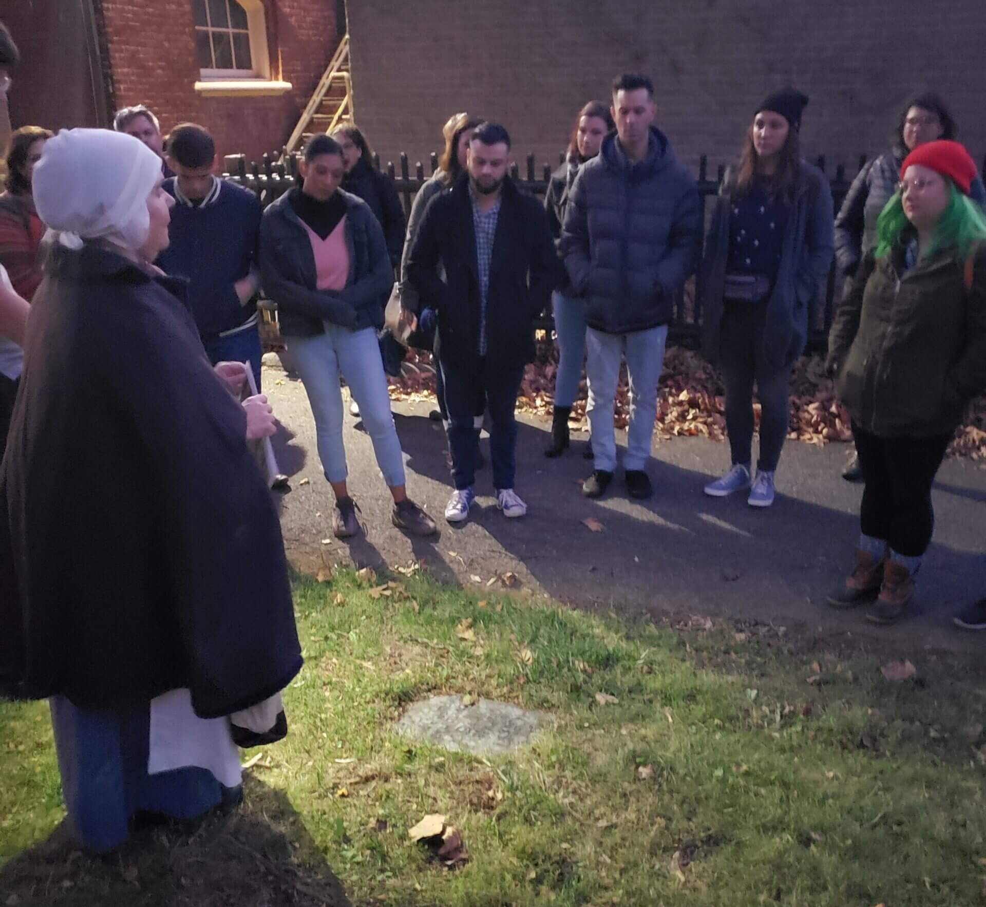 Guests and their docent at a cemetery as part of the Death & Dying Tour