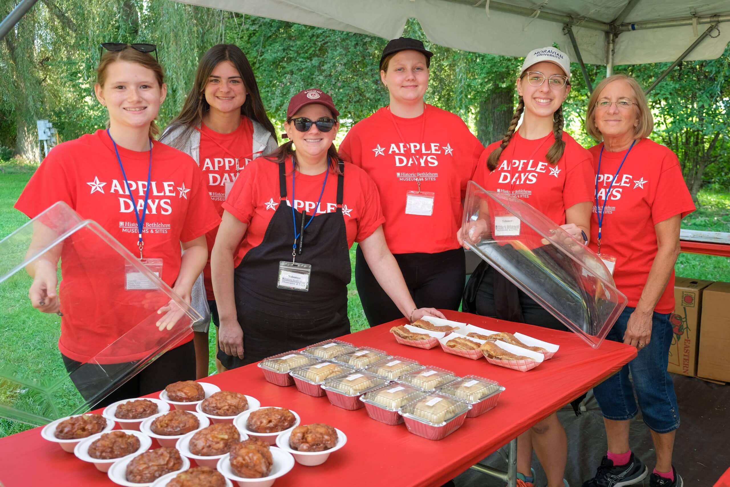 Apple Days Volunteers with various apple baked goods