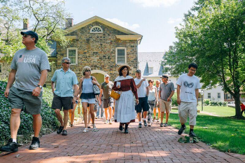 A docent guiding a tour group on the Historic Pub Tour during the summer