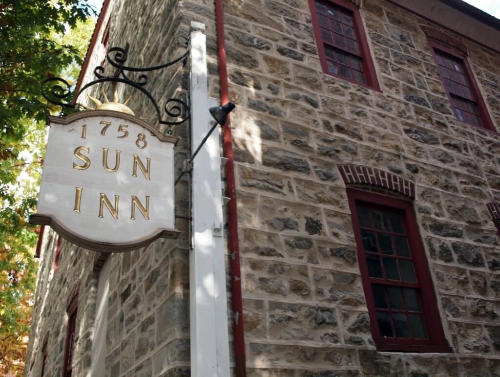 The wooden and gold sign for the historic 1758 Sun Inn