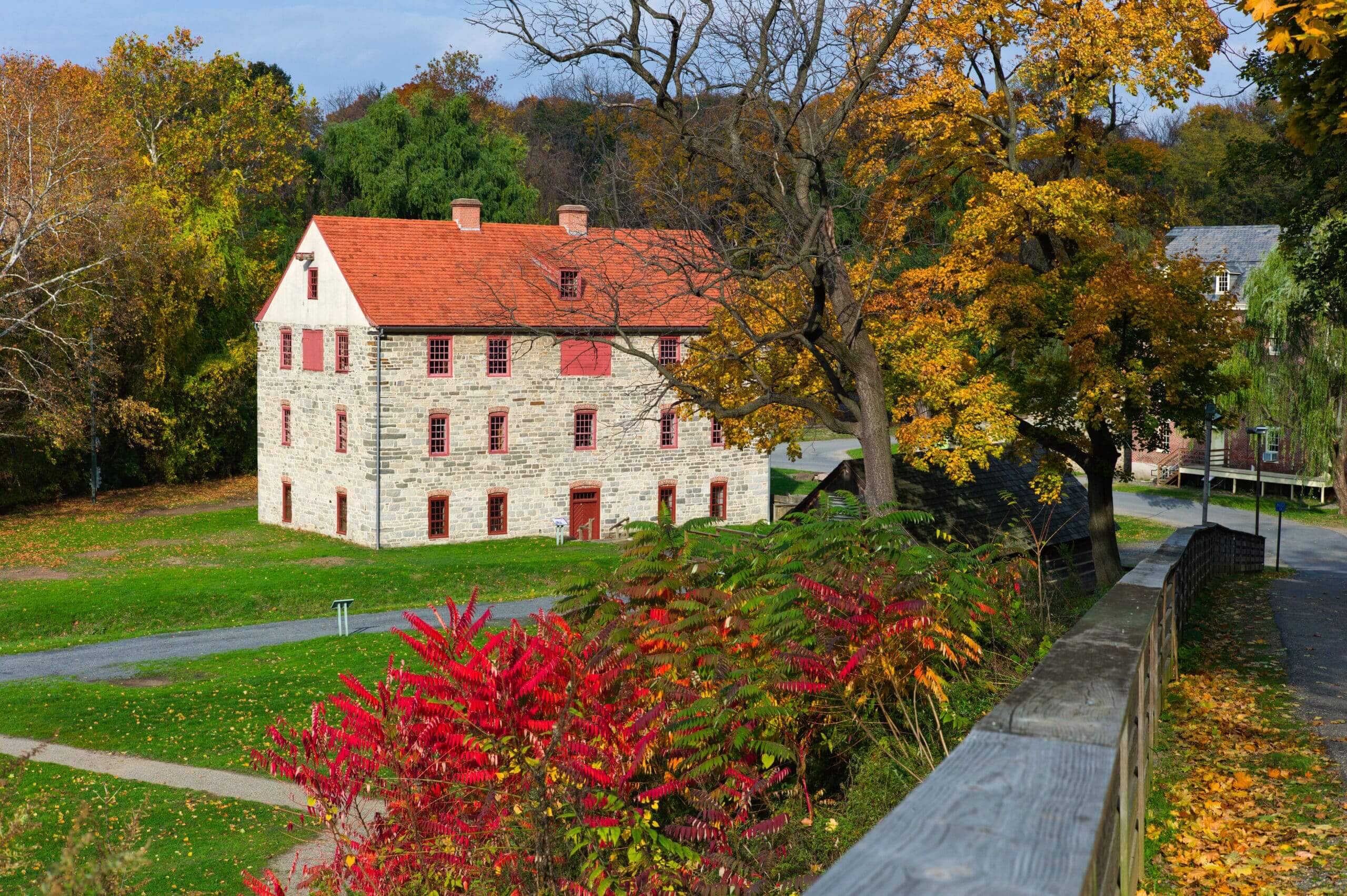 The 1761 Tannery surrounded by bright, colorful leaves in the fall