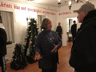 A volunteer giving a tour of the Gemeinhaus and the Moravian Museum