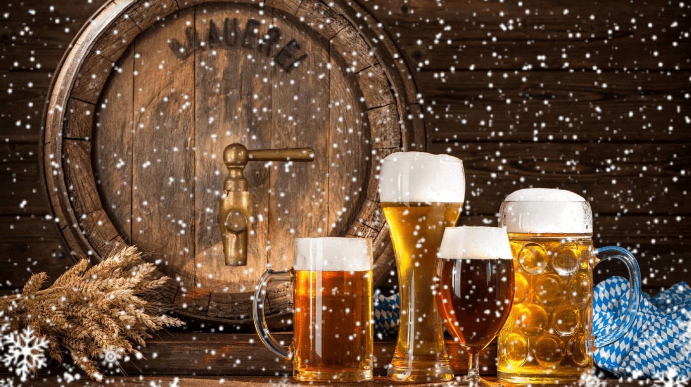 Glasses of beer with snow falling in front of them