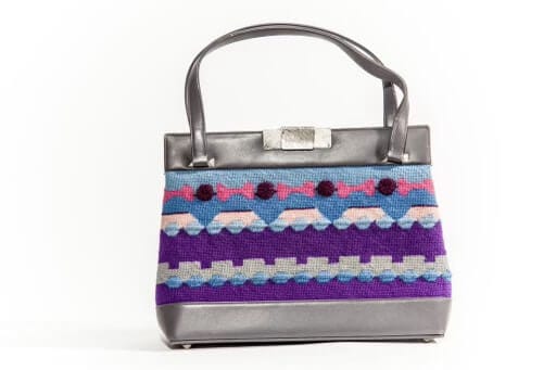 A blue, pink, purple and silver bag with knit rows