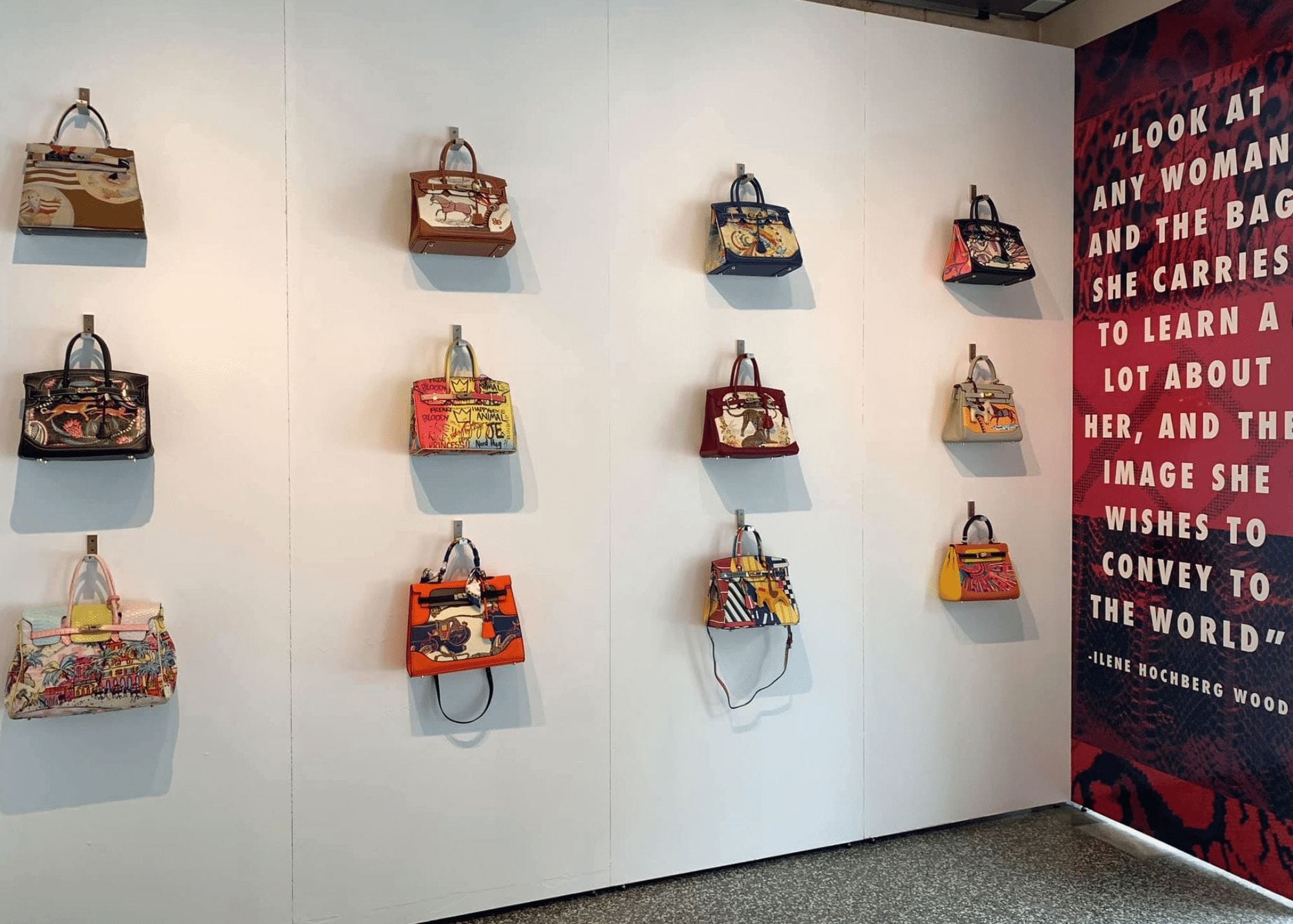 A wall with various purses as a part of the PURSEonality: A Stylish Handbag History exhibition