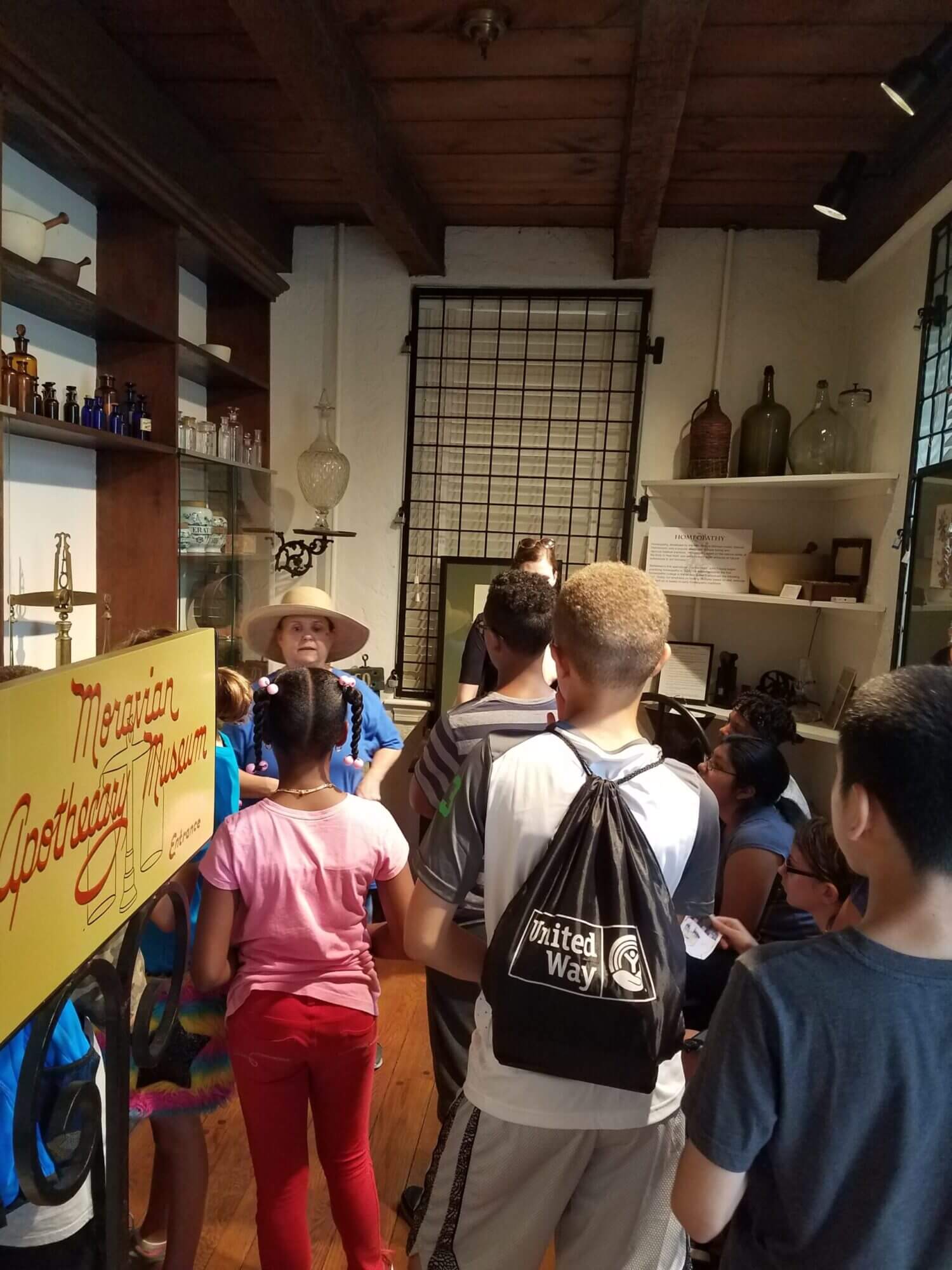 Students taking a school tour at the Apothecary with a volunteer guide