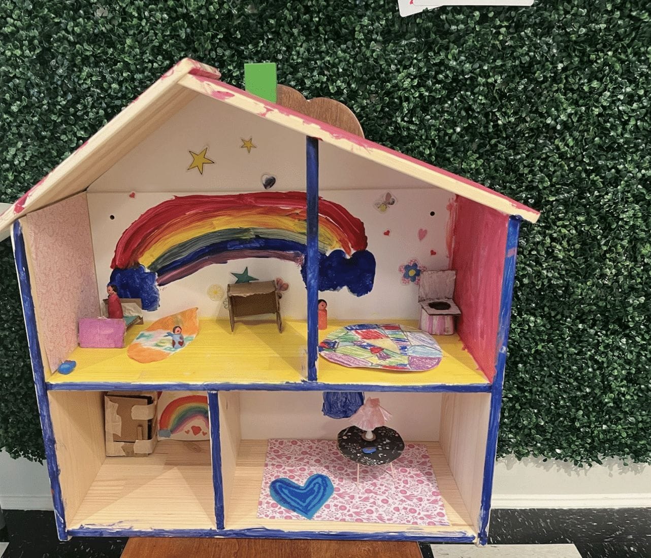 A doll house featuring a rainbow design.