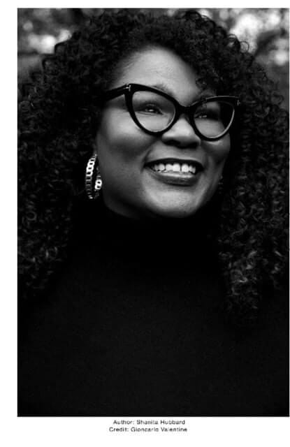 black and white image of author shanita hubbard wearing glasses