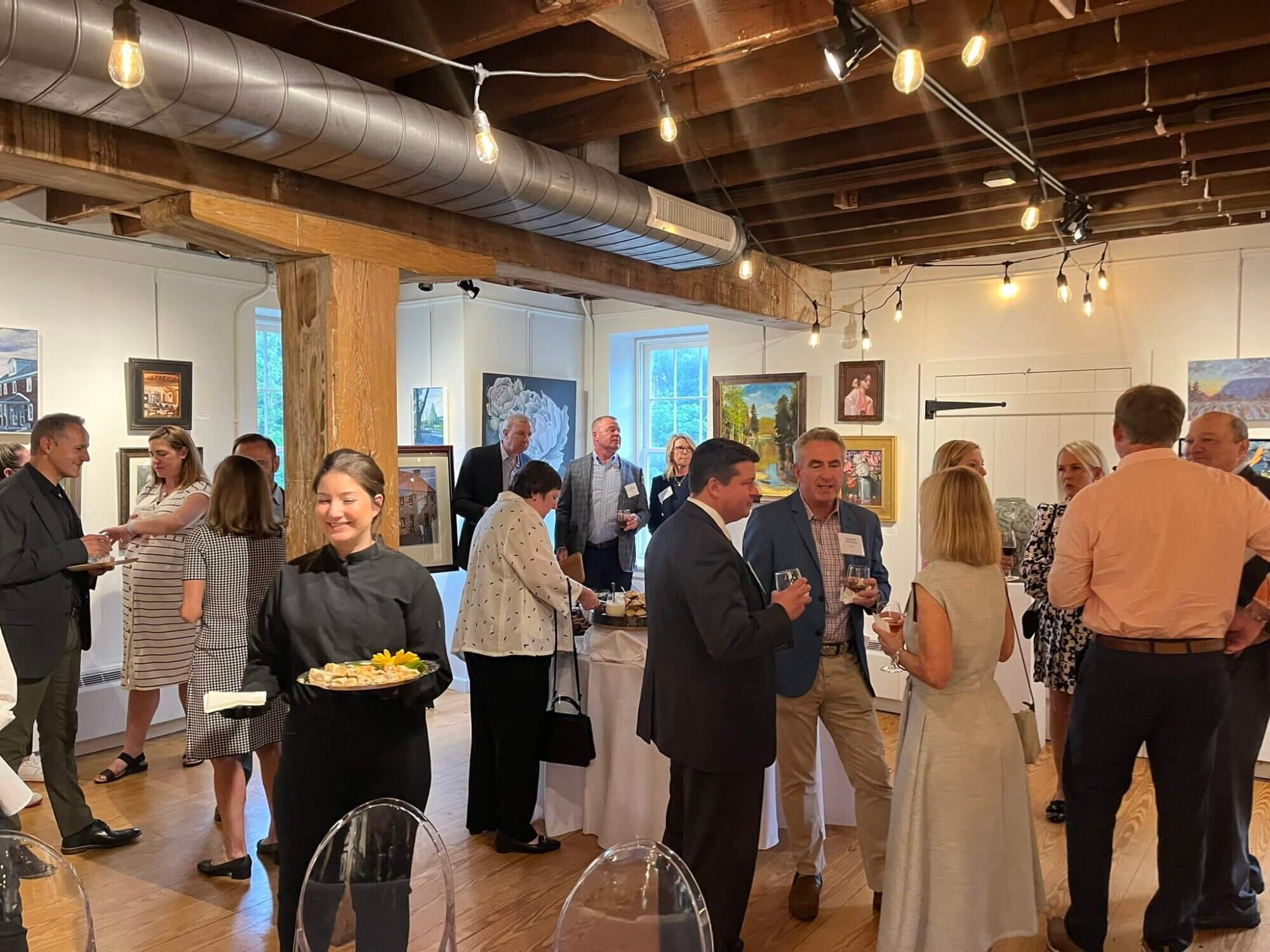 Guests mingling in the 1869 Luckenbach Mill at the CEO event 