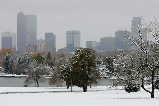 DENVER - OCTOBER 26: The Denver skyline emerges behind a snow blanketed Denver City Park after an early season snowstorm October 26, 2006 in Denver, Colorado. The autumn snowstorm dumped up to 18 inches on parts of Colorado overnight. (Photo by Doug Pensinger/Getty Images)