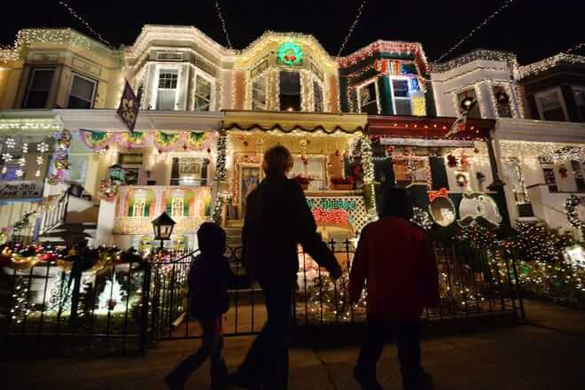 People enjoy the Christmas lights on the 700 block of 34th Street in the Hampden community of Baltimore, Maryland on December 12, 2014. The display called "Miracle on 34th Street" dates back to 1947 and attracts thousands of tourists each year. AFP PHOTO/MLADEN ANTONOV (Photo by MLADEN ANTONOV / AFP) (Photo by MLADEN ANTONOV/AFP via Getty Images)